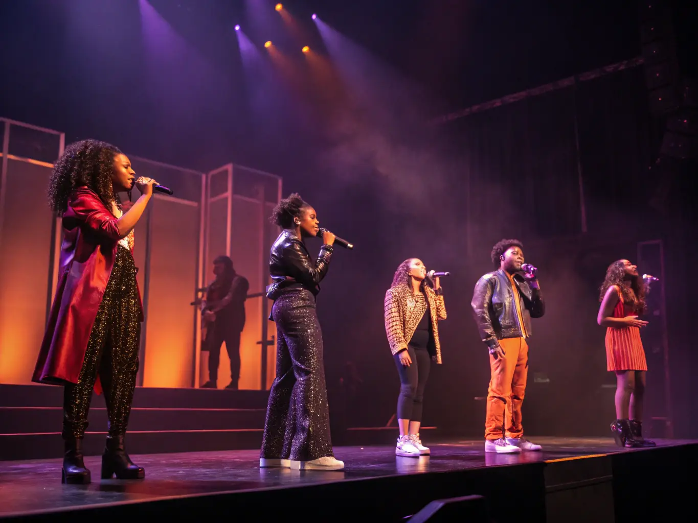 A dynamic image of performers engaged in a live juggling performance on a stage, showcasing the excitement and artistry of EXTREME JONGLERIE's live performance events.